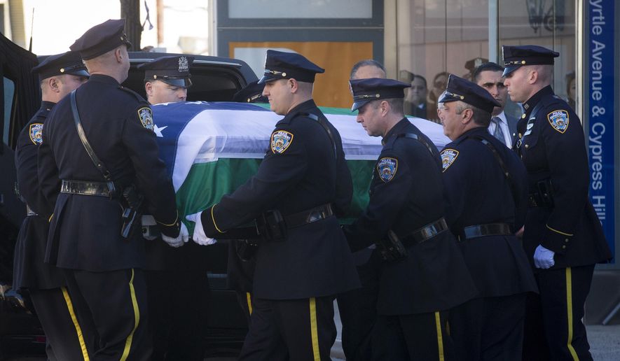 New York City police officers carry the casket of New York Police Department officer Rafael Ramos at his wake at Christ Tabernacle Church, in the Glendale section of Queens, where he was a member, Friday, Dec. 26, 2014, in New York.  Ramos was killed Dec. 20 along with his partner, Officer Wenjian Liu, as they sat in their patrol car in Brooklyn. The shooter, Ismaaiyl Brinsley, later killed himself. (AP Photo/John Minchillo)