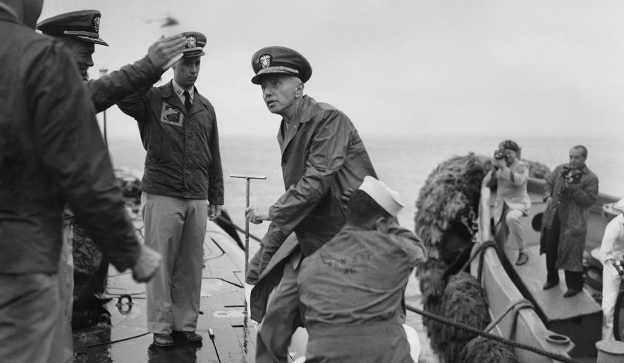 Rear Adm. Hyman G. Rickover, father of nuclear powered submarines, boards the USS Nautilus from the Navy Tug 534 in the Narrows below Brooklyn, New York on August 25, 1958. Cdr. William Anderson, head showing at left, awaits to greet the admiral aboard the U.S. Navy&#39;s first nuclear sub. Anderson is skipper of the Nautilus. Saluting at left center is Lt. Donald P. Hall, gunnery officer of the Nautilus. The craft returned earlier from 4-month voyage. (AP Photo/Pool)