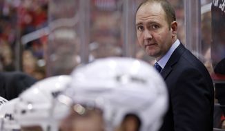 FILE - In this Nov. 14, 2014, file photo, New Jersey Devils head coach Peter DeBoer stands in the bench area during the third period of an NHL hockey game against the Washington Capitals, in Washington. The Devils fired DeBoer on Friday, Dec. 26, 2014. (AP Photo/Alex Brandon, File)