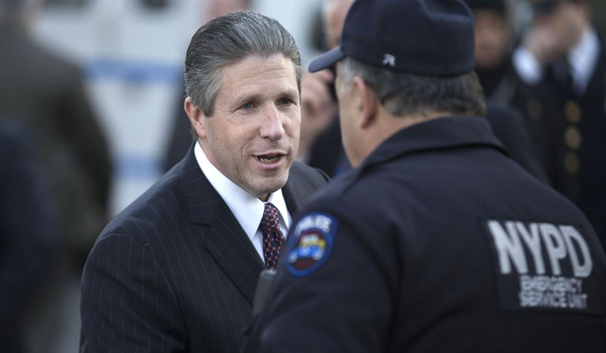 Patrolman&#39;s Benevolent Association president Patrick Lynch shakes the hand of an officer outside the wake of officer Rafael Ramos at Christ Tabernacle Church, in the Glendale section of Queens, Friday, Dec. 26, 2014, in New York. Ramos was killed Dec. 20 along with his partner, Officer Wenjian Liu, as they sat in their patrol car on a Brooklyn street. The shooter, Ismaaiyl Brinsley, later killed himself. (AP Photo/John Minchillo)