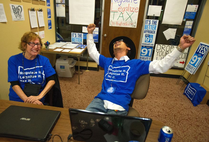 File--In this Nov. 4, 2014, file photo, Matthew Yook, a field organizer for Measure 91, celebrates early returns that favor the Oregon Legalized Marijuana Initiative with Elvy Musikka, a medical marijuana recipient, at their downtown headquarters in Eugene, Ore. The legalization of marijuana for personal use is one of Oregon's top 2014 stories. (AP Photo/The Register-Guard, Brian Davies, file)