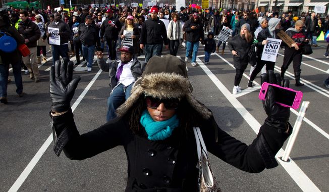 Demonstrators march on Pennsylvania Avenue toward Capitol Hill on Dec. 13. The ongoing protests have cost District police about $3 million. (Associated Press)