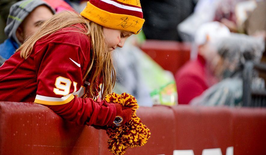 A young fan shows dejection as the Washington Redskins play the Dallas Cowboys the at FedExField, Landover, Md., Sunday, December 28, 2014. (Andrew Harnik/The Washington Times)