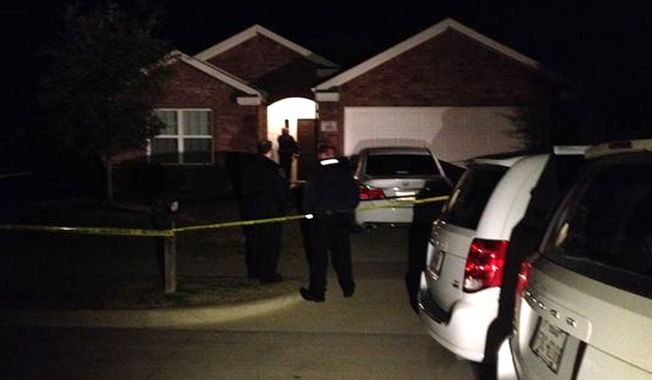 This image provided by WFAA-TV shows the scene outside of a home in Crowley,Texas, Sunday, Dec. 28, 2014, where officers responding to a report of a suicide attempt found four people dead inside, according to police. Authorities are still investigating. (AP Photo/WFAA-TV.com)