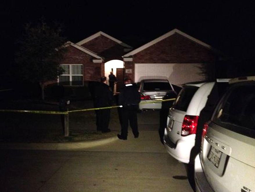 This image provided by WFAA-TV shows the scene outside of a home in Crowley,Texas, Sunday, Dec. 28, 2014, where officers responding to a report of a suicide attempt found four people dead inside, according to police. Authorities are still investigating. (AP Photo/WFAA-TV.com)