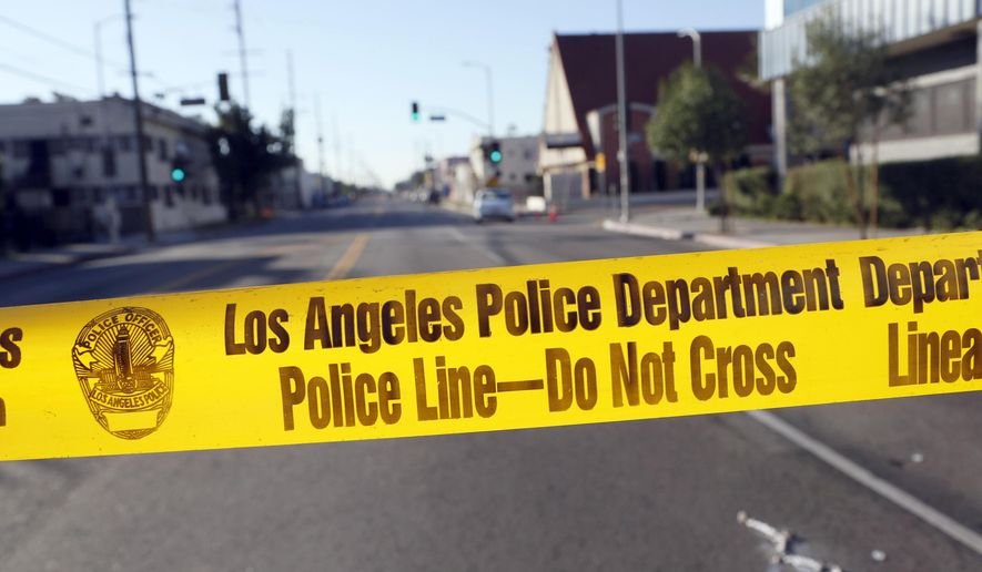 Police crime scene tape is stretched across a street in South Central Los Angles on Monday, Dec. 29, 2014. (AP Photo/Nick Ut) ** FILE **