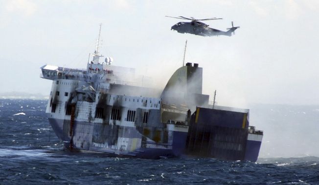 In this image released by the Italian Navy, smoke billows from the Italian-flagged Norman Atlantic that caught fire in the Adriatic Sea, Monday, Dec. 29, 2014. Fighting high winds and stormy seas, helicopter rescue crews on Monday evacuated the last of hundreds of people trapped aboard a Greek ferry that caught fire off Albania. (AP Photo/Italian Navy, ho)