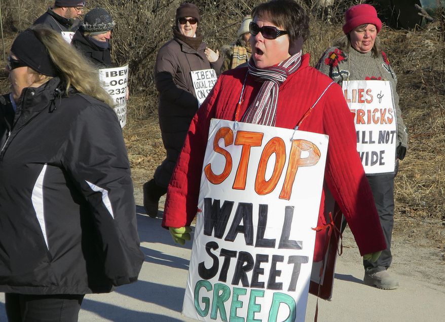 Striking FairPoint Communication workers walk a picket line outside the company's state headquarters Tuesday, Dec. 30, 2014 in Portland, Maine. The National Labor Relations Board has dismissed complaints accusing the FairPoint of bargaining in bad faith. The unions said they were appealing the decision, and that striking workers will continue to work to force the telecommunications company back to the bargaining table. (AP Photo/David Sharp)