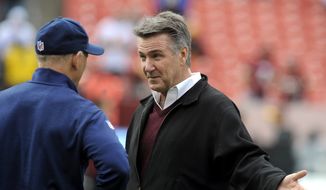 Redskins President and General Manager Bruce Allen, right, talks with Dallas Cowboys defensive coordinator Rod Marinelli prior to the start of their NFL football game in Landover, Md., Sunday, Dec. 28, 2014. The Cowboys defeated the Redskins 44-17.  (AP Photo/Richard Lipski)
