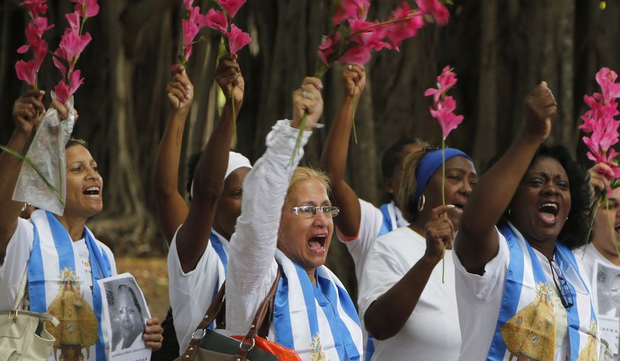 Members of the Ladies in White, a Cuban dissident group, participate in a demonstration Sunday in Havana. Cuban authorities have reportedly detained overnight dozens of pro-democracy and free speech activists this week, including at least three members of the nation&#39;s political opposition ahead of a planned protest art performance in Havana. (Associated Press)
