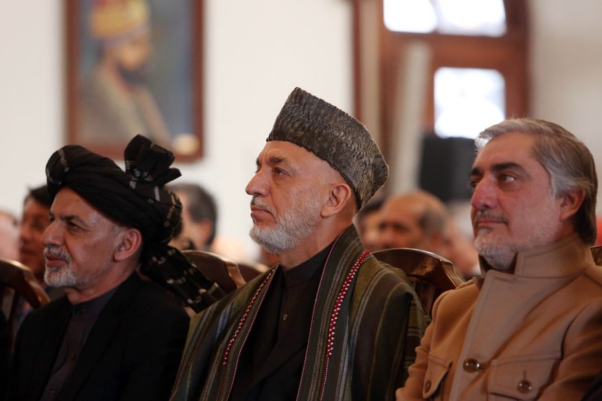 Afghan President Ashraf Ghani, left, former President Hamid Karzai, center, and Chief Executive Abdullah Abdullah, right, attend a ceremony marking the completion of security transition to Afghan security forces in Kabul, Thursday, Jan. 1, 2015. Afghan police are investigating a rocket strike on a wedding party that killed at least 28 people, many of them women and children, an official said Thursday, as President Ashraf Ghani marked the country’s transition to full sovereignty after the 13-year international military mission to rid Afghanistan of insurgents officially ended. (AP Photo/Rahmat Gul)