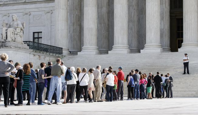 In a Tuesday, Oct. 14, 2014 file photo, visitors line up to enter the U.S. Supreme Court in Washington. Several cases from states that still ban gay marriage have advanced to the high court. (AP Photo/J. Scott Applewhite, File)