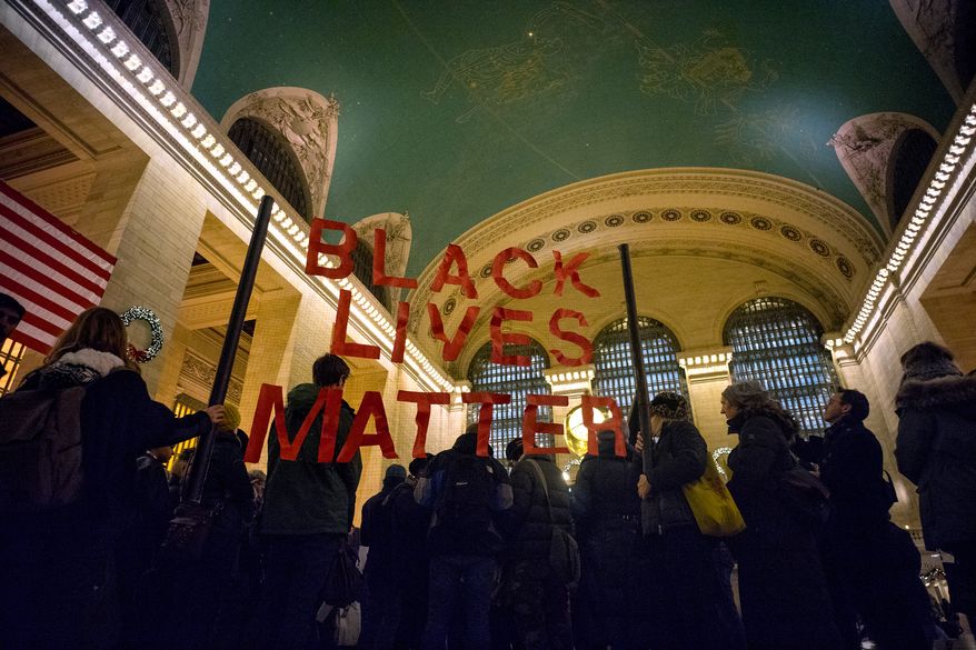 A group of protesters gather at Grand Central Terminal in New York, Thursday, Jan. 1, 2015. A number of protests have been staged around the country following recent grand jury decisions not to indict white police officers in New York and Ferguson, Mo., over the deaths of unarmed black men. (AP Photo/Craig Ruttle)