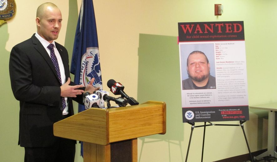 Nathan Emery, Homeland Security Investigations agent in charge, stands next to a poster of Jeremiah Malfroid, a 33-year-old California man whose name and image were transmitted by the &quot;Operation Predator&quot; app in connection with a child pornography sting.  (AP Photo/Andrew Welsh-Huggins)
