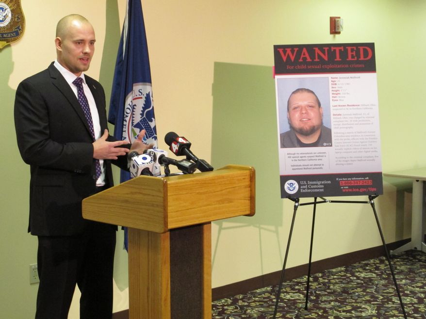 Nathan Emery, Homeland Security Investigations agent in charge, stands next to a poster of Jeremiah Malfroid, a 33-year-old California man whose name and image were transmitted by the &quot;Operation Predator&quot; app in connection with a child pornography sting.  (AP Photo/Andrew Welsh-Huggins)