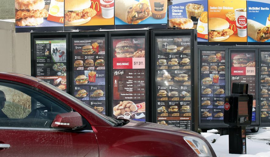 In this Jan. 26, 2009, file photo, a customer looks at the menu at a McDonald&#x27;s drive-thru in Williamsville, N.Y. (AP Photo/David Duprey, File)