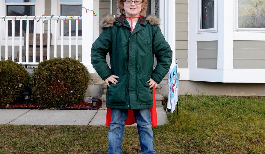 In this Monday, Dec. 15, 2014 photo, Ewan Drum poses with his cape at his home in New Haven, Mich. Drum is the founder of Super Ewan, a nonprofit to help the homeless. (AP Photo/The Port Huron Times Herald, Andrew Jowett) NO SALES