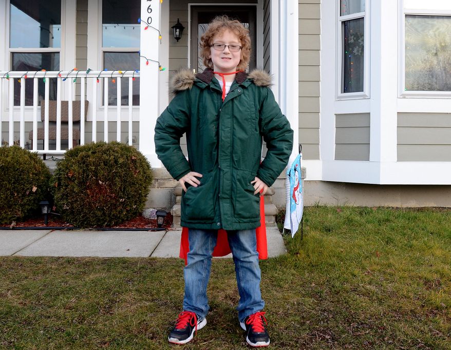 In this Monday, Dec. 15, 2014 photo, Ewan Drum poses with his cape at his home in New Haven, Mich. Drum is the founder of Super Ewan, a nonprofit to help the homeless. (AP Photo/The Port Huron Times Herald, Andrew Jowett) NO SALES