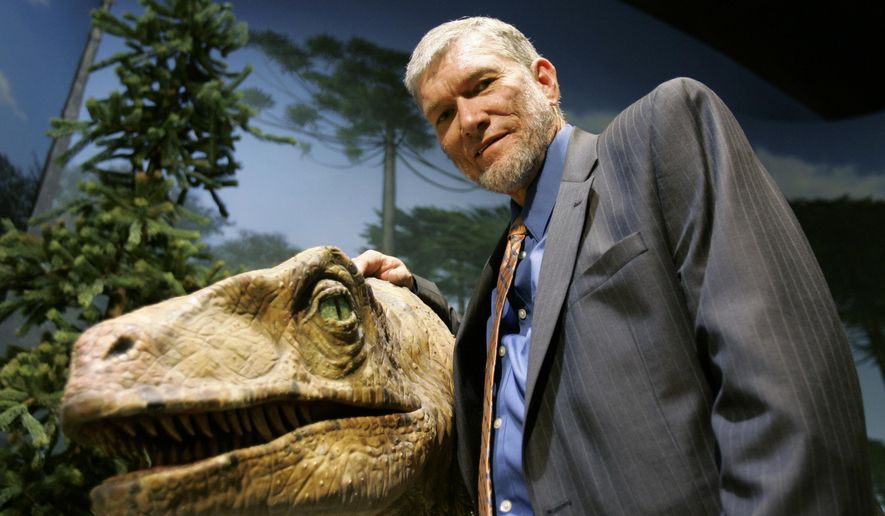 In this May 24, 2007 photo, Ken Ham, founder of the nonprofit ministry Answers in Genesis, poses with one of his favorite animatronic dinosaurs during a tour of the Creation Museum in Petersburg, Ky. A legal battle of biblical proportions could be brewing in Kentucky over the state’s withdrawal of a tax incentive for a religious-themed Noah’s Ark attraction. The Christian ministry building the ark, Answers in Genesis, is challenging the state’s decision to reject a sales tax rebate that could be worth $18 million. (AP Photo/Ed Reinke, File)