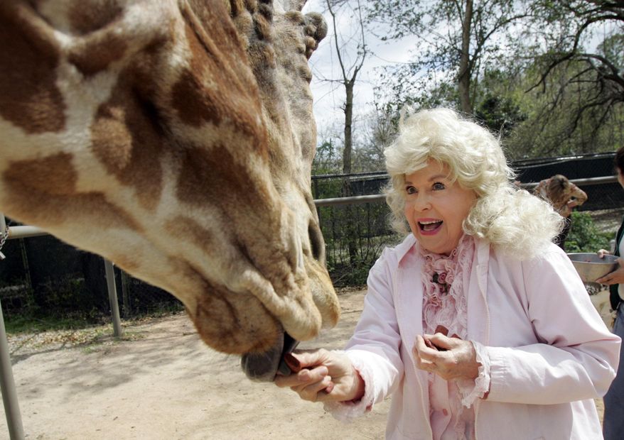FILE - In this March 4, 2009 file photo, Donna Douglas, who starred in the television series "The Beverly Hillbillies" tours the Audubon Zoo in New Orleans. Douglas, who played the buxom tomboy Elly May Clampett on the hit 1960s sitcom has died. Douglas, who was 82, died Thursday, Jan. 1, 2015, in Baton Rouge, where she lived, her niece, Charlene Smith, said. (AP Photo/Bill Haber, File)