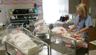 A nurse checks the heartbeat of a baby at Jamestown, N.D., hospital on Aug. 6, 2009. (Associated Press/The Jamestown Sun, John M. Steiner) **FILE**