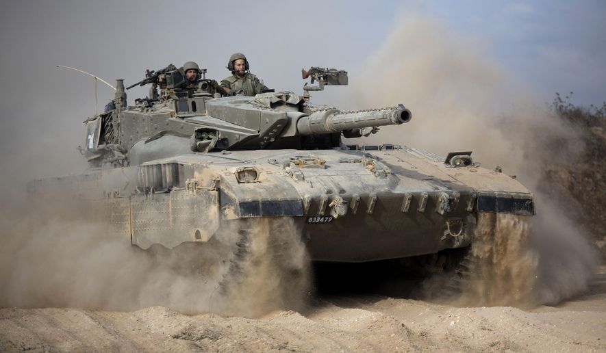 In this Friday, July 18, 2014, file photo, an Israeli tank moves into position near Israel and Gaza border. (AP Photo/Dusan Vranic, File)