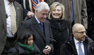 Bill and Hillary Clinton, center, greet people as they exit the funeral for Mario Cuomo at the Church of St. Ignatius Loyola in New York, Tuesday, Jan. 6, 2015. (AP Photo/Seth Wenig)