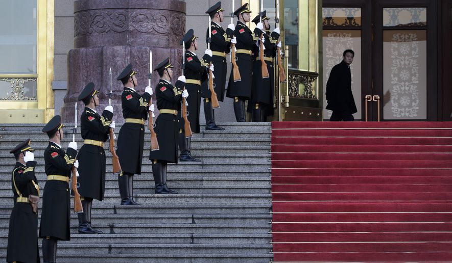 A Chinese officer, top right, looks as members of honor guard rehearse for a welcome ceremony held by Chinese President Xi Jinping for visiting Costa Rica&#39;s President Luis Guillermo Solis at the main entrance of the Great Hall of the People in Beijing, China Tuesday, Jan. 6, 2015. (AP Photo/Andy Wong)