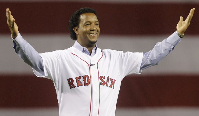 FILE - In this April 4, 2010, file photo, former Boston Red Sox pitcher Pedro Martinez greets the crowd before throwing the ceremonial first pitch before the opening game of the baseball season between the Red Sox and New York Yankees, in Boston. Martinez was elected to the National Baseball Hall of Fame Tuesday, Jan. 6, 2015. (AP Photo/Elise Amendola, File)