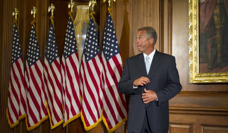 House Speaker John Boehner of Ohio waits for the next Member of Congress to pose for a photograph during a ceremonial re-enactment of the House oath-of-office, Tuesday, Jan. 6, 2015, on Capitol Hill in Washington. (AP Photo/Cliff Owen)