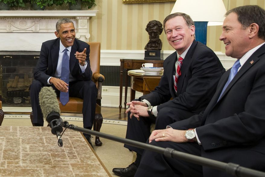 President Barack Obama, left, reacts after National Governors Association Vice Chairman, Utah Gov. Gary Herbert, right, was hit with a microphone during a meeting with the executive committee of the National Governors Association in the Oval Office of the White House in Washington, Tuesday, Jan. 6, 2015. At center is National Governors Association Chairman, Colorado Gov. John Hickenlooper. (AP Photo/Evan Vucci)