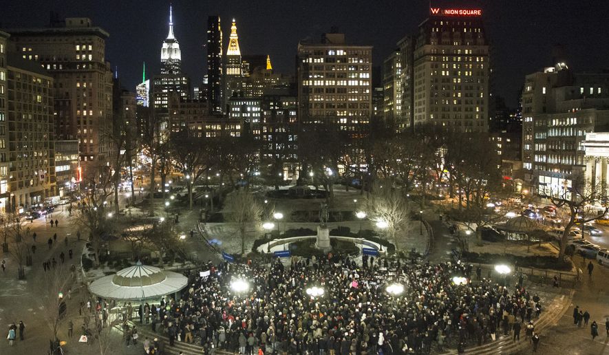 Mourners gather during a rally in support of Charlie Hebdo, a French satirical weekly newspaper that fell victim to an terrorist attack, Wednesday, Jan. 7, 2015, at Union Square in New York. French officials say 12 people were killed when masked gunmen stormed the Paris offices of the periodical that had caricatured the Prophet Muhammad. (AP Photo/John Minchillo)