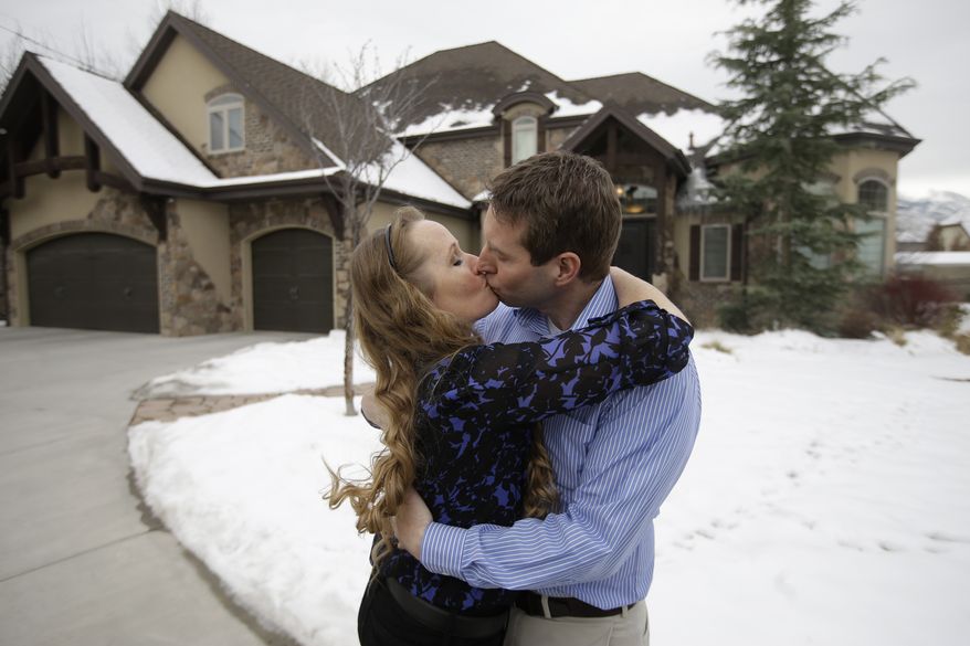Jeff Bennion and his wife Tanya kiss in front of their home near Salt Lake City. He and other husbands will  appear in a new reality TV show, "My Husband's Not Gay." They say they're fulfilled in their relationships with their wives even though they're attracted to other men. Gay rights groups have lambasted the show since it was announced by the TLC network last month. (AP Photo/Rick Bowmer)