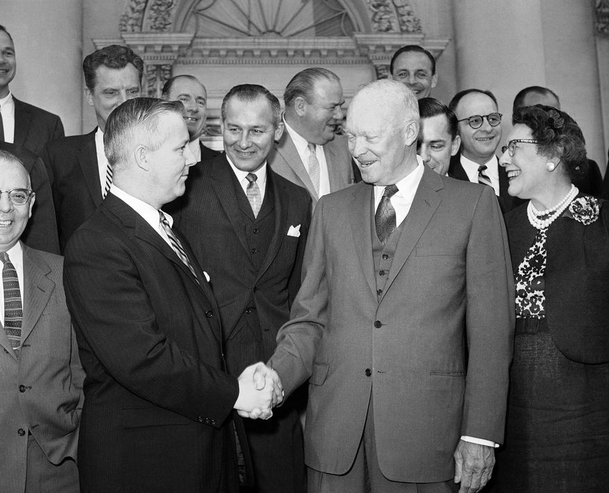 FILE - In this May 12, 1960, file photo, President Dwight Eisenhower, front right, shakes hands with Rep. Arch Moore, of West Virginia, as he poses with a group of Republican congressmen after breakfast at the White House, in Washington. Moore, whose guilty pleas to federal corruption charges overshadowed his record as his era's most successful Republican in Democrat-dominated West Virginia, died Wednesday, Jan. 7, 2015. He was 91. (AP Photo/Bill Allen, File)