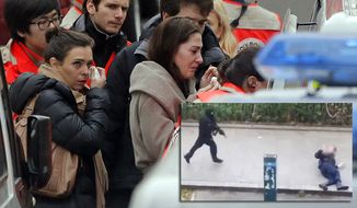 People are evacuated outside the French satirical newspaper Charlie Hebdo&#39;s office, in Paris, Wednesday, Jan. 7, 2015. Masked gunmen stormed the offices of a French satirical newspaper Wednesday, killing at least 11 people before escaping, police and a witness said. The weekly has previously drawn condemnation from Muslims.  (AP Photo/Francois Mori)