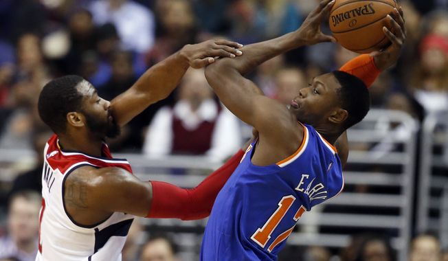 Washington Wizards guard John Wall (2) fouls New York Knicks forward Cleanthony Early (17) during the second half of an NBA basketball game, Wednesday, Jan. 7, 2015, in Washington. The Wizards won 101-91.(AP Photo/Alex Brandon)