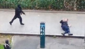 Cell phone footage captures the moment two gunmen shoot and kill a police officer on a Paris street during an attack on magazine Charlie Hebdo. 
