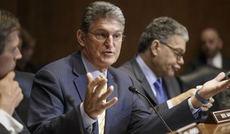 Sen. Joe Manchin, D-W.V., a Democratic sponsor of the long-stalled Keystone XL pipeline bill, flanked by Sen. Al Franken, D-Minn., right, and Sen. Martin Heinrich, D-N.M., left, makes his plea at the Senate Energy and Natural Resources Committee markup on the controversial project, Thursday, Jan. 8, 2015, on Capitol Hill in Washington. As promised by Republican leaders who now hold the majority in Congress, the Keystone bill is at the top of their agenda after it fell short of passage in December when Democrats ruled the Senate. (AP Photo/J. Scott Applewhite)