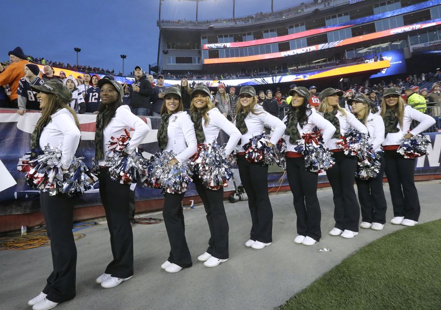 New England Patriots cheerleaders prepare to depart the field following an NFL football game against the Detroit Lions, Sunday, Nov. 23, 2014, in Foxborough, Mass. (AP Photo/Steven Senne)