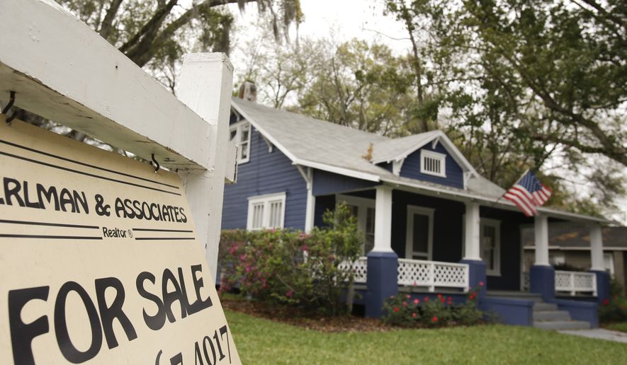 FILE - In this March 7, 2014 photo, a realty sign hangs in front of a home for sale in Orlando, Fla. Freddie Mac reports on average U.S. mortgage rates on Thursday, Jan. 8, 2015. (AP Photo/John Raoux, File)