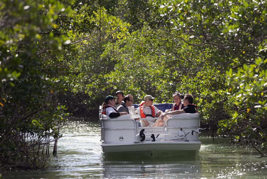 U.S. Secretary of the Interior Sally Jewell, second from right, tours a mangrove island in Everglades National Park with with scientists and federal and park service officials, Friday, Jan. 9, 2015 in Everglades National Park, Fla. Jewell said Friday that the bipartisan unity and state and federal cooperation behind Everglades restoration is a model for similar projects nationwide. (AP Photo/Wilfredo Lee)