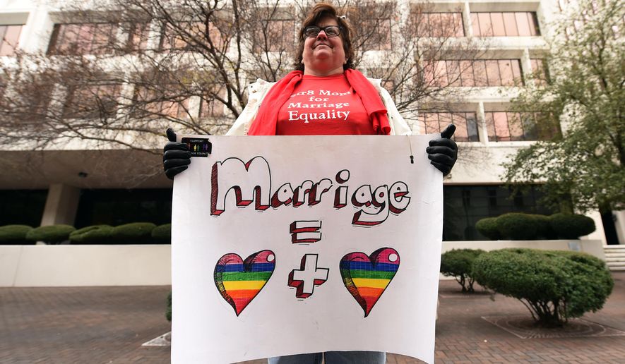 Helen Barnes holds a sign of support for gay marriage outside of the 5th U.S. Circuit Court of Appeals, Friday, Jan. 9, 2015, in New Orleans. Opponents and supporters of gay marriage argued their sides before the 5th U.S. Circuit Court of Appeals, on gay marriage bans in Texas, Louisiana and Mississippi . (AP Photo/Stacy Revere)