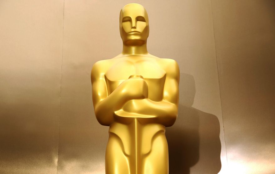FILE - In this Feb. 28, 2014 file photo, an Oscar statue stands on the red carpet as preparations are made for the 86th Academy Awards in Los Angeles. Oscar nominees in all 24 categories will hear their name announced live next week. Academy Awards producers Craig Zadan and Neil Meron said Friday, Jan. 9, 2015, they are launching a new tradition of revealing all Oscar contenders in a live news conference. (Photo by Matt Sayles/Invision/AP, File)
