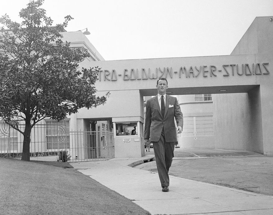 FILE - In this April 22, 1959, file photo, Samuel Goldwyn, Jr., poses outside the main gate at Metro-Goldwyn-Mayer studios in the Hollywood section of Los Angeles. Goldwyn Jr., a champion of the independent film movement and son to one of the founding fathers of Hollywood cinema, died died Friday, Jan. 9, 2015, from congestive heart failure, his son told the Los Angeles Times. He was 88. (AP Photo/Ellis R. Bosworth, File)
