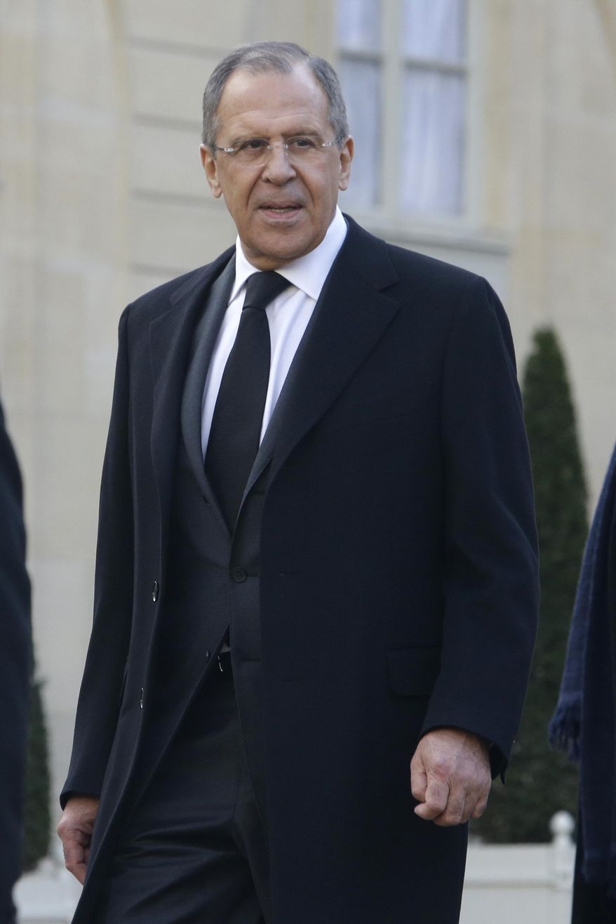 Russian Foreign Minister Sergey Lavrov leaves the Elysee Palace to board a bus to join a rally, in Paris, Sunday, Jan. 11, 2015. A rally of defiance and sorrow, protected by an unparalleled level of security, on Sunday will honor the 17 victims of three days of bloodshed in Paris that left France on alert for more violence. (AP Photo/Thibault Camus)