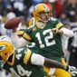 Green Bay Packers quarterback Aaron Rodgers (12) throws a pass during the first half of an NFL divisional playoff football game against the Dallas Cowboys Sunday, Jan. 11, 2015, in Green Bay, Wis. (AP Photo/Matt Ludtke)