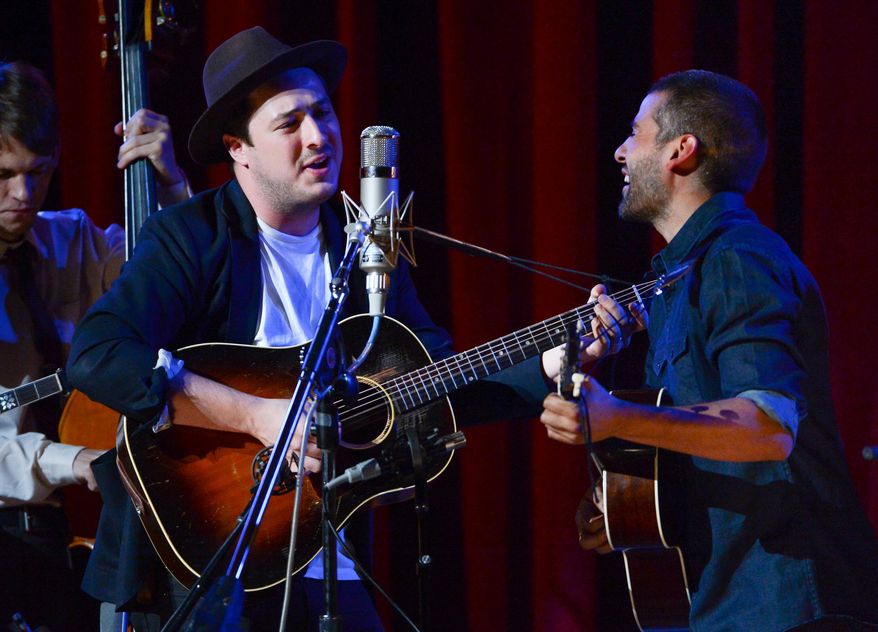 FILE - In this Sept. 29, 2013 file photo, musicians Marcus Mumford, left, and Oscar Isaac perform together during "Another Day, Another Time: Celebrating the Music of Inside Llewyn Davis" at The Town Hall in New York. Fans of the Coen brothers' amused, affectionate portrait of the 1960s Greenwich Village folk scene _ and of banjo-playing, guitar-plucking Americana in general _ will relish this recording of a 2013 New York concert celebrating the music of the movie "Inside Llewyn Davis." (Photo by Evan Agostini/Invision/AP, File)