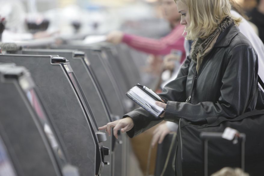 FILE - In this Oct. 27, 2009 file photo, a traveler checks in for her flight at an American Airlines ticket kiosk at Lambert St. Louis International Airport in St. Louis. Thieves with stolen usernames and passwords have broken into customer accounts at American and United airlines and in some cases booked free trips, the airlines said Monday, Jan. 12, 2015. (AP Photo/Jeff Roberson, File)