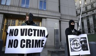 Supporters of Ross William Ulbricht hold signs during the jury selection for his trial outside of federal court in New York, Tuesday, Jan. 13, 2015. (AP Photo/Seth Wenig)