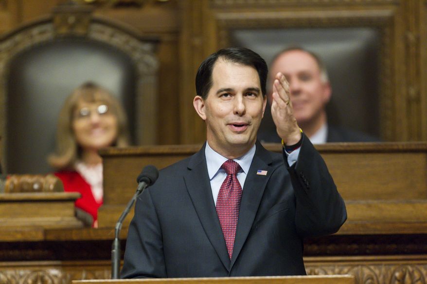 Wisconsin Gov. Scott Walker acknowledges people in the gallery during Governor's State of the State address to a joint session of the Legislature in the Assembly chambers at the state Capitol, Tuesday, Jan. 13, 2015, in Madison, Wis. (AP Photo/Andy Manis)